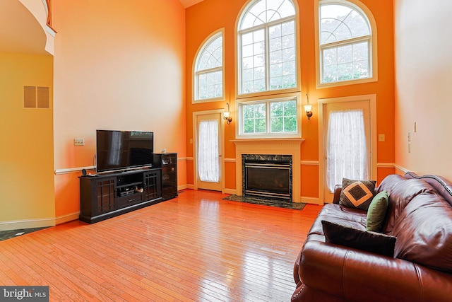 82 Granville Way, Exton, PA 19341 - living area featuring a healthy amount of sunlight, visible vents, a fireplace, and a high ceiling