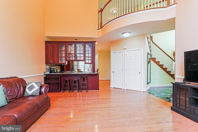 82 Granville Way, Exton, PA 19341 - living area featuring baseboards, stairs, light wood finished floors, and a high ceiling
