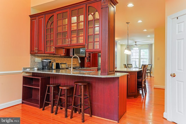82 Granville Way, Exton, PA 19341 - bar with baseboards, ceiling fan, light wood-type flooring, and decorative backsplash