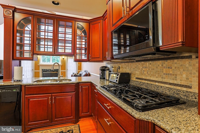 82 Granville Way, Exton, PA 19341 - kitchen with a sink, light stone countertops, black appliances, and dark brown cabinets
