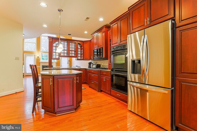 82 Granville Way, Exton, PA 19341 - kitchen featuring a kitchen island, light wood-style floors, visible vents, and black appliances