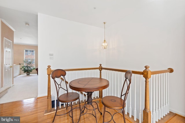 staircase with wood finished floors and baseboards