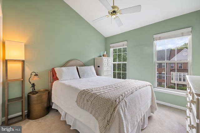 carpeted bedroom with baseboards, high vaulted ceiling, and ceiling fan