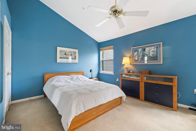 carpeted bedroom featuring lofted ceiling, baseboards, and ceiling fan