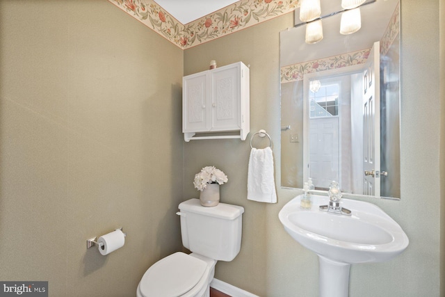bathroom featuring toilet and a sink