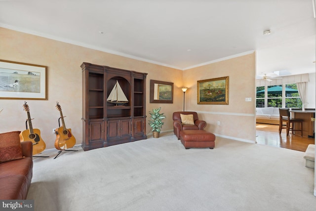 living area with ornamental molding, carpet floors, and baseboards