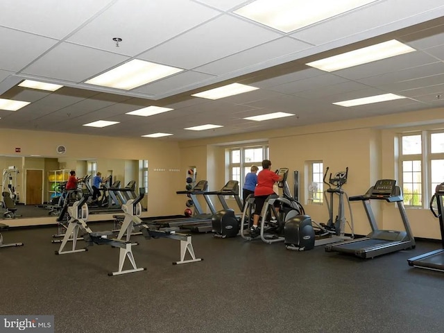 gym with plenty of natural light and a drop ceiling