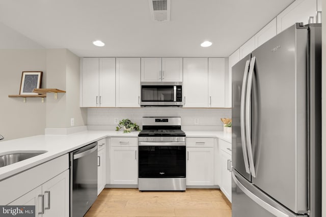 50 Florida Ave NE Unit 312, Washington, DC 20002 - kitchen featuring stainless steel appliances, recessed lighting, white cabinets, open shelves, and light countertops