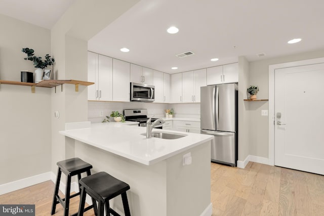 50 Florida Ave NE Unit 312, Washington, DC 20002 - kitchen featuring appliances with stainless steel finishes, a sink, a peninsula, baseboards, and recessed lighting