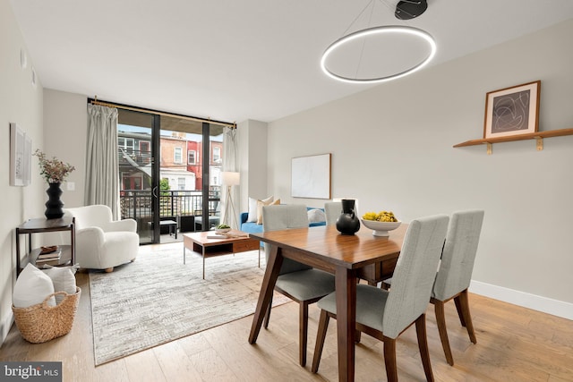 50 Florida Ave NE Unit 312, Washington, DC 20002 - dining room featuring wood finished floors, baseboards, and expansive windows