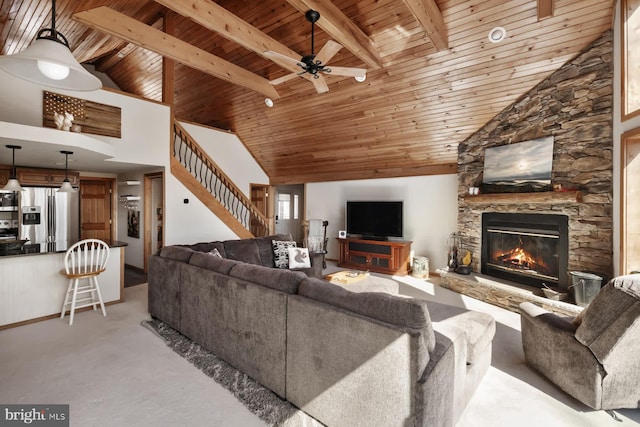 carpeted living room with wood ceiling, a ceiling fan, a fireplace, stairs, and high vaulted ceiling