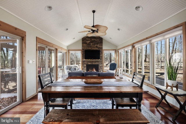sunroom / solarium featuring vaulted ceiling and wood finished floors