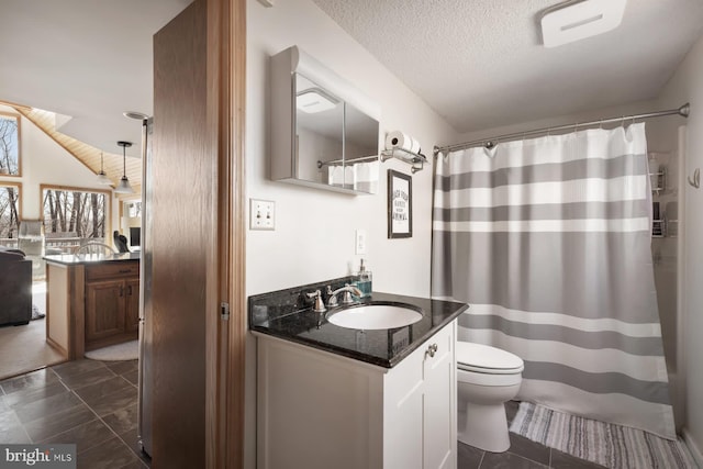 full bath featuring toilet, vanity, curtained shower, a textured ceiling, and marble look tile flooring