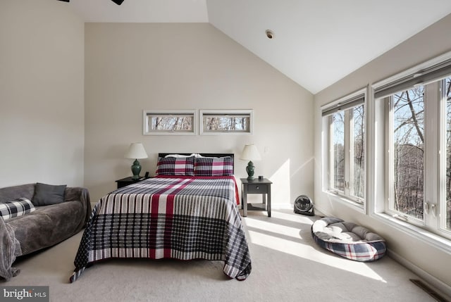 carpeted bedroom with lofted ceiling and baseboards