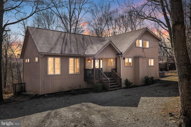 rustic home featuring roof with shingles