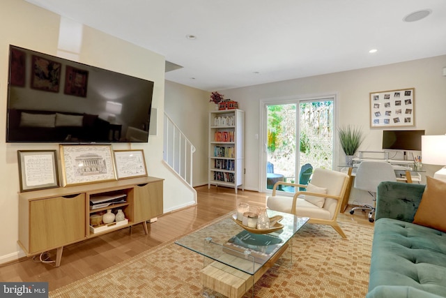 living area featuring recessed lighting, baseboards, and wood finished floors
