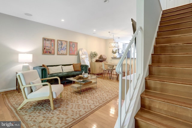 living room with recessed lighting, hardwood / wood-style flooring, and stairs