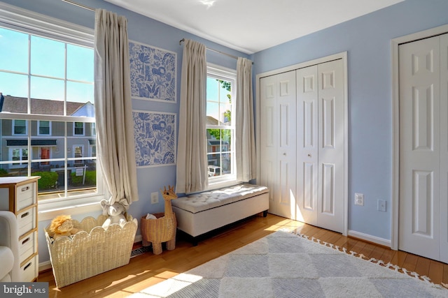living area featuring baseboards and hardwood / wood-style floors