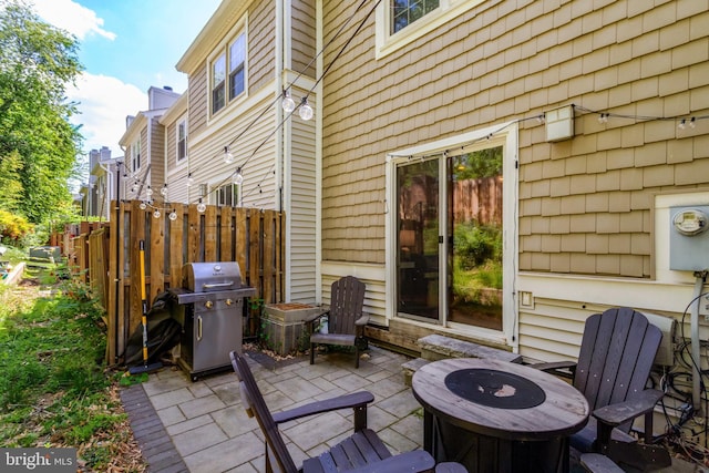 view of patio / terrace with area for grilling, an outdoor fire pit, and fence