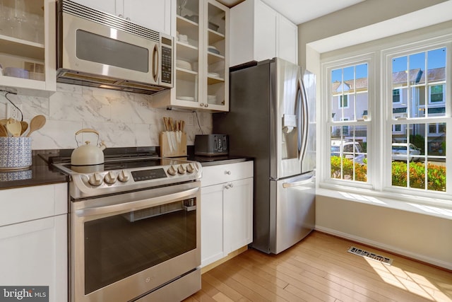 kitchen featuring dark countertops, a healthy amount of sunlight, and appliances with stainless steel finishes