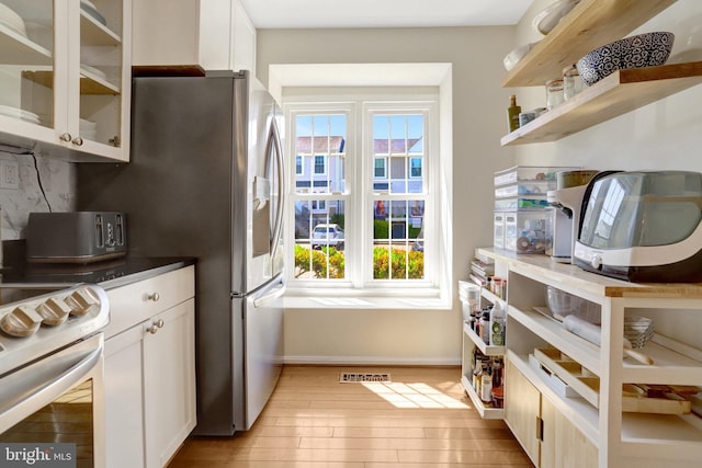 kitchen with plenty of natural light, visible vents, decorative backsplash, and baseboards