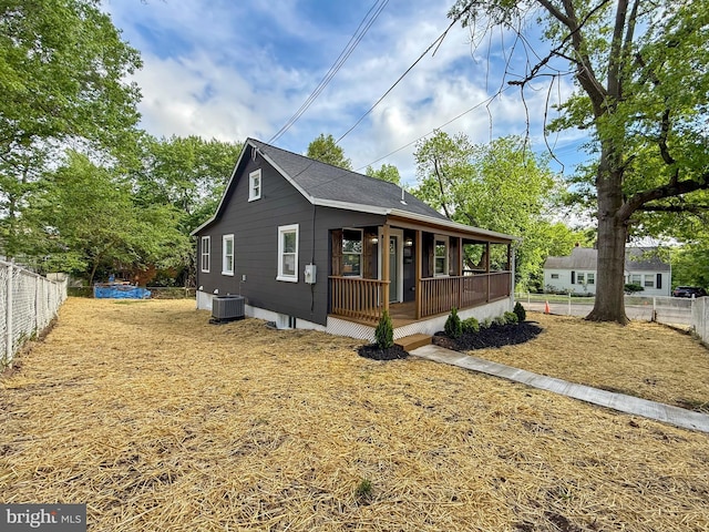 view of front of property featuring cooling unit, a porch, and fence