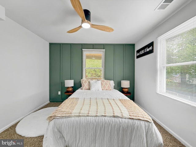 bedroom featuring visible vents, baseboards, a ceiling fan, and carpet floors