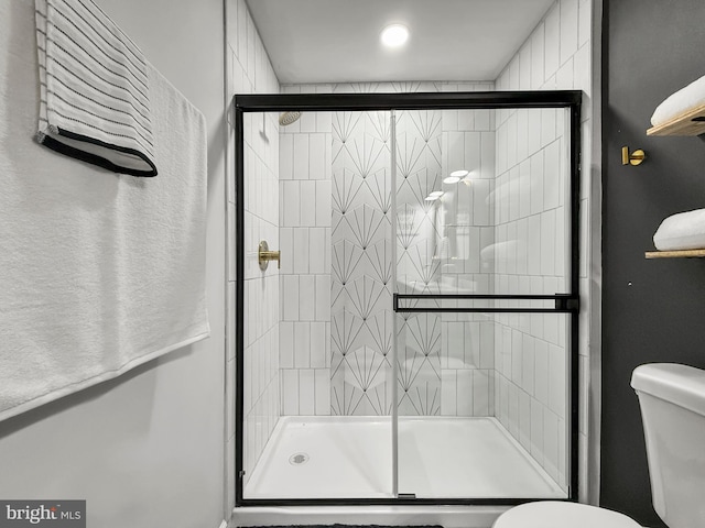 bathroom with toilet and a shower stall