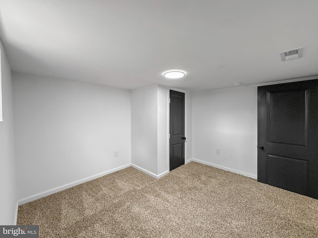 finished basement featuring carpet flooring, baseboards, and visible vents