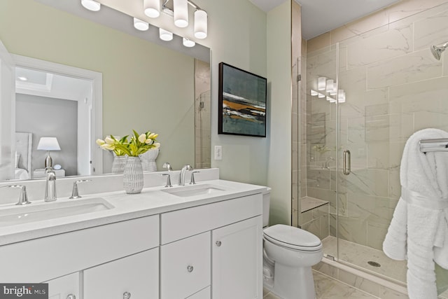 full bathroom featuring toilet, marble finish floor, a shower stall, and a sink