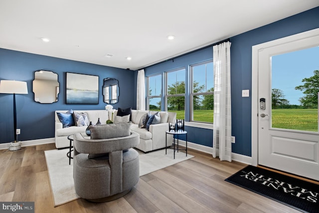 living area featuring a wealth of natural light, baseboards, and recessed lighting