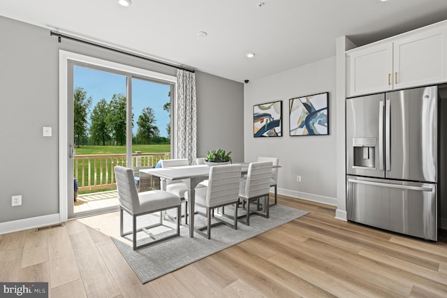dining space with light wood finished floors, baseboards, visible vents, and recessed lighting