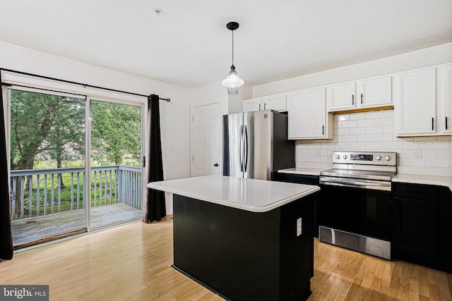 kitchen featuring stainless steel appliances, tasteful backsplash, light countertops, and white cabinets