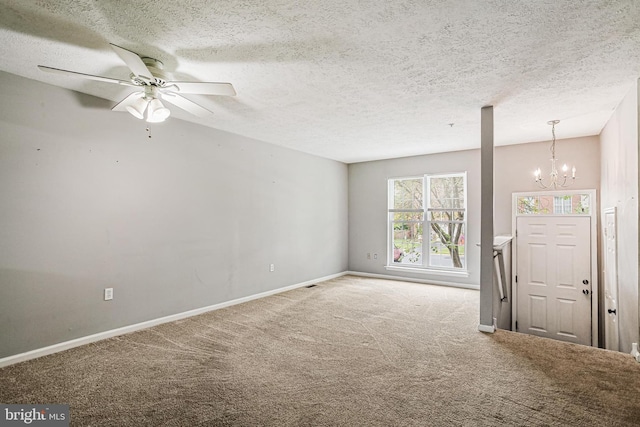 unfurnished living room with baseboards, carpet flooring, a textured ceiling, and ceiling fan with notable chandelier