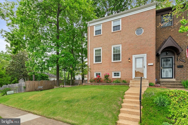 view of front of house with entry steps and brick siding