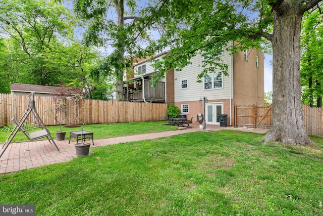 view of yard with a patio area and french doors