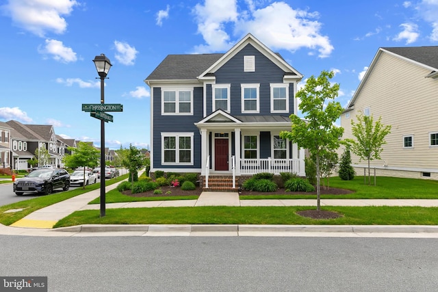view of front of house featuring a porch, a front yard, and a residential view
