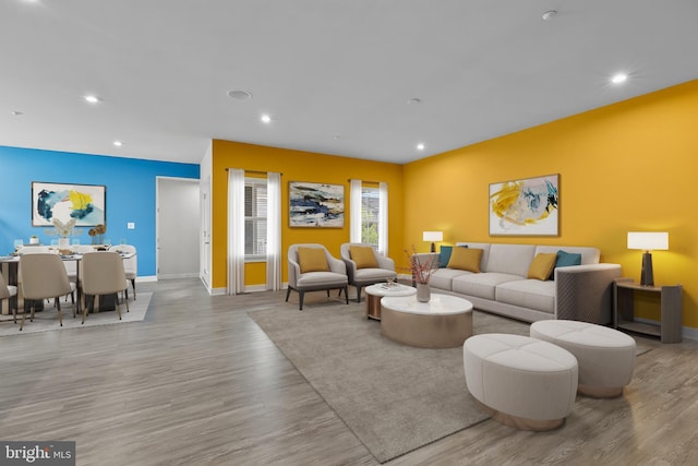 living area with wood finished floors, baseboards, and recessed lighting