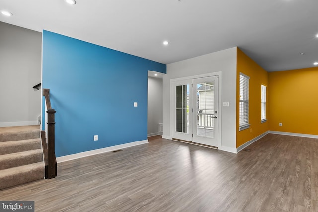 unfurnished living room featuring wood finished floors, baseboards, and recessed lighting