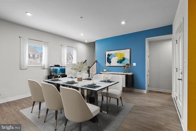 dining area with wood finished floors, baseboards, and recessed lighting