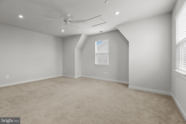 bonus room featuring plenty of natural light, light colored carpet, recessed lighting, ceiling fan, and baseboards