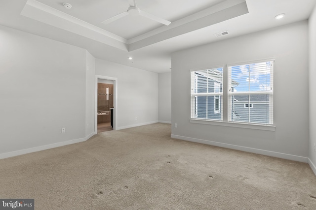 spare room featuring carpet floors, a ceiling fan, baseboards, recessed lighting, and a tray ceiling