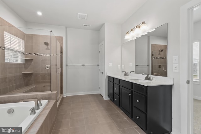 full bath featuring a stall shower, double vanity, a garden tub, tile patterned flooring, and healthy amount of natural light