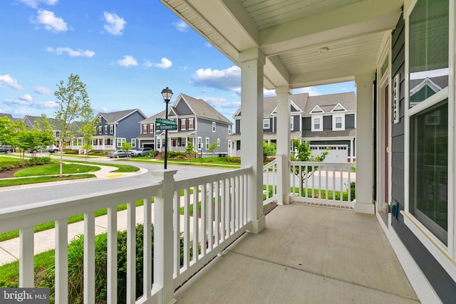 balcony featuring a residential view and covered porch