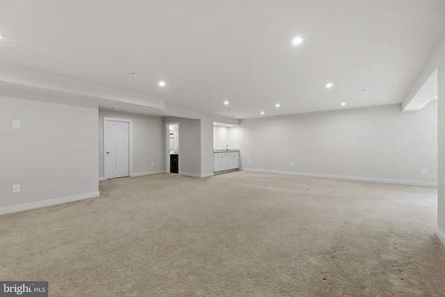 basement with recessed lighting, baseboards, and light carpet