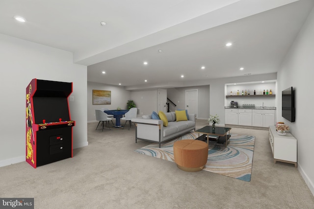 living area with stairs, recessed lighting, light carpet, baseboards, and a dry bar