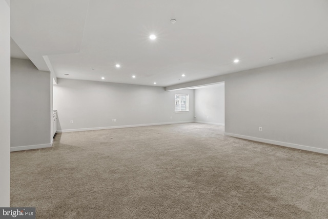 below grade area featuring recessed lighting, light colored carpet, and baseboards