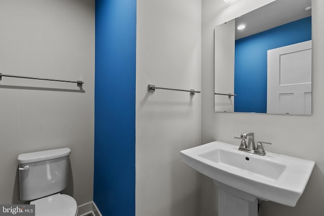 bathroom with toilet and a sink