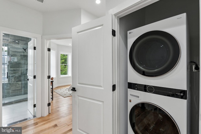 660 Columbia Rd NW, Washington, DC 20001 - laundry room with stacked washer / dryer, light wood-type flooring, and recessed lighting