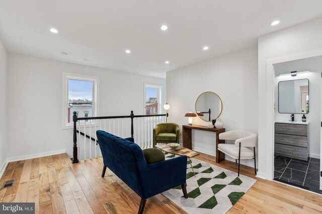 660 Columbia Rd NW, Washington, DC 20001 - living area with light wood finished floors, an upstairs landing, recessed lighting, and baseboards